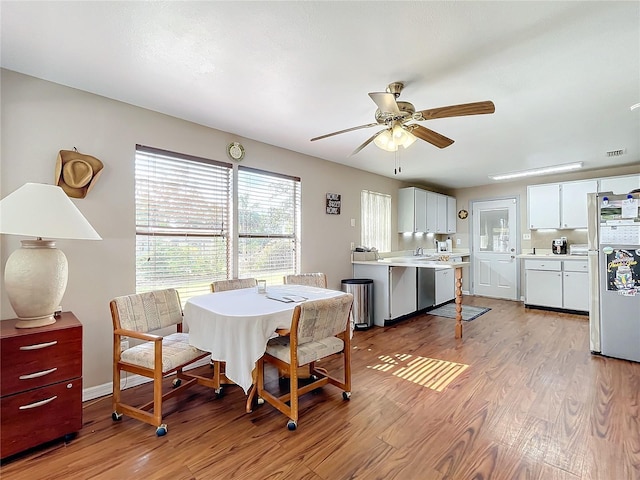 dining room featuring ceiling fan and light wood-type flooring