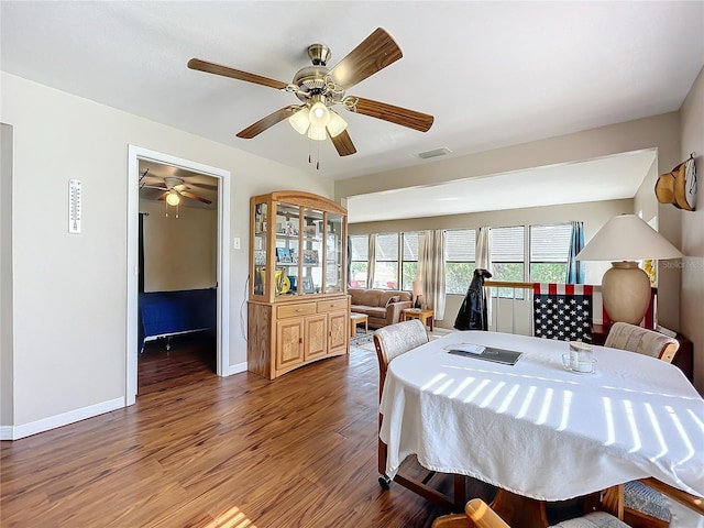 dining room with hardwood / wood-style flooring and ceiling fan