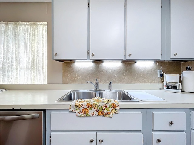 kitchen with backsplash, stainless steel dishwasher, and sink