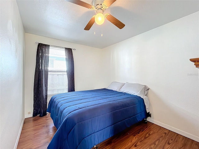 bedroom featuring dark wood-type flooring and ceiling fan