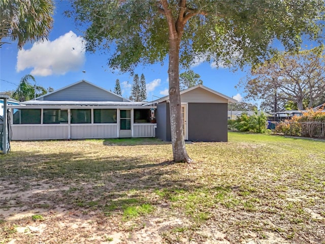 view of front of property with a front yard and a sunroom