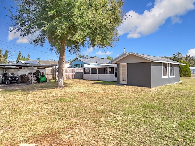 back of property featuring a yard