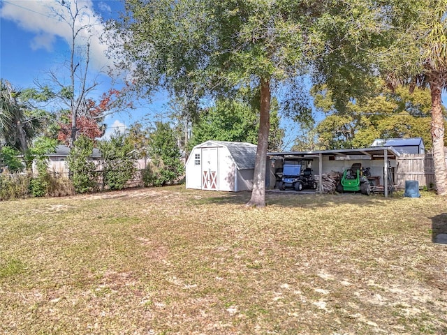 view of yard with a carport and a storage unit