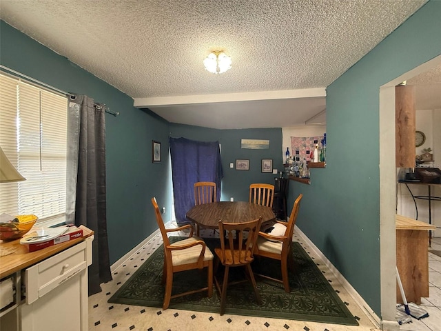 dining area featuring a textured ceiling