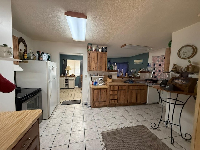 kitchen with light tile patterned flooring, sink, white dishwasher, a textured ceiling, and stainless steel electric range