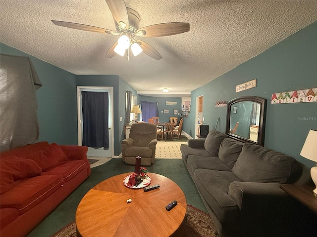 living room with ceiling fan, carpet flooring, and a textured ceiling