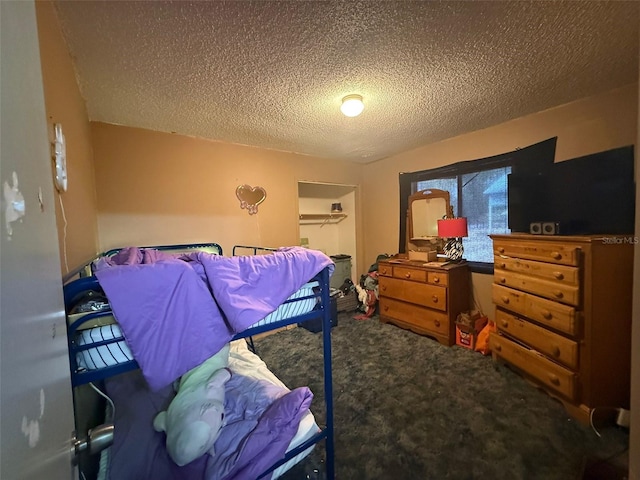 carpeted bedroom with a textured ceiling