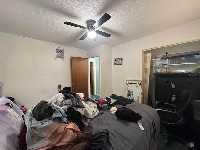 bedroom with ceiling fan and a textured ceiling