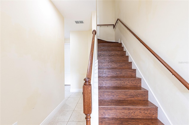 stairs with tile patterned floors