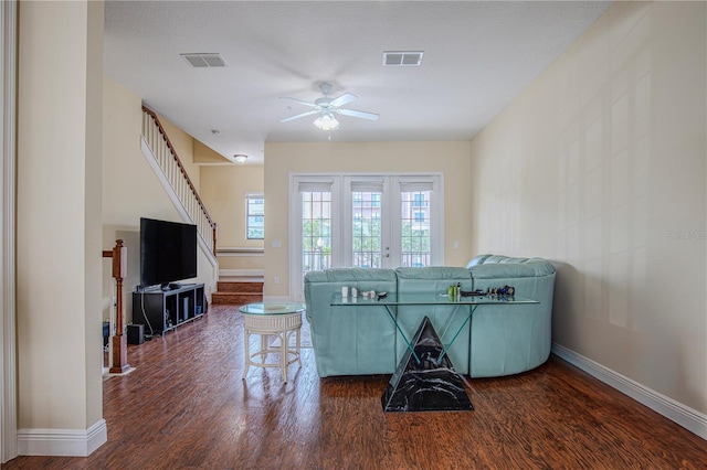 living room featuring ceiling fan and dark hardwood / wood-style flooring