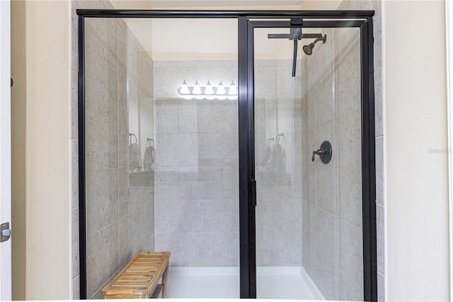 bathroom with a shower with door