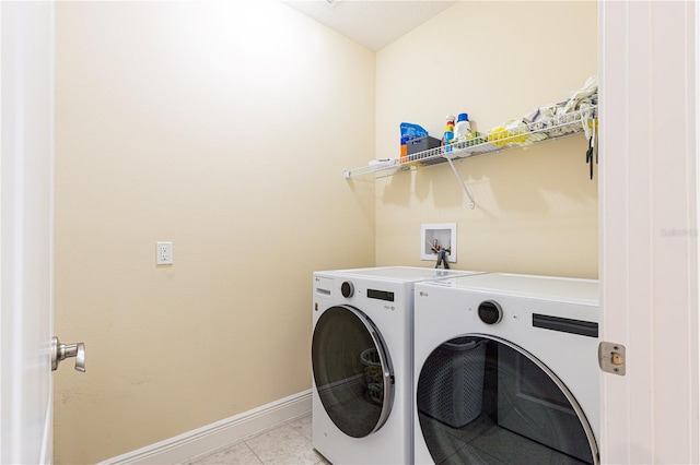 washroom with separate washer and dryer and light tile patterned floors