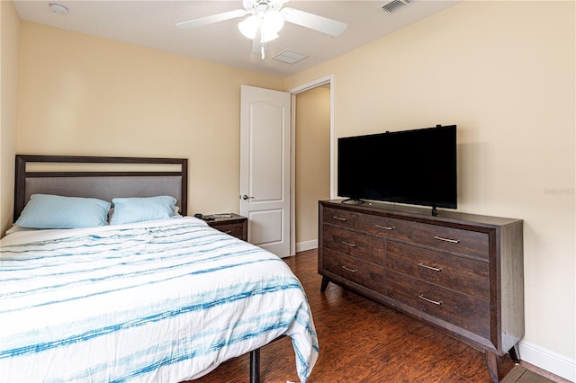 bedroom with dark hardwood / wood-style floors and ceiling fan