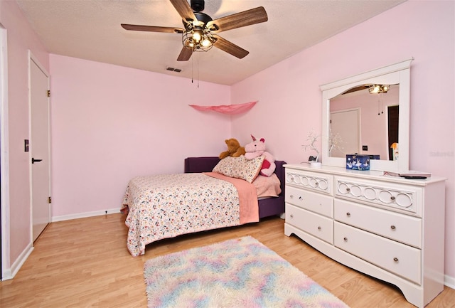 bedroom with light hardwood / wood-style floors and ceiling fan