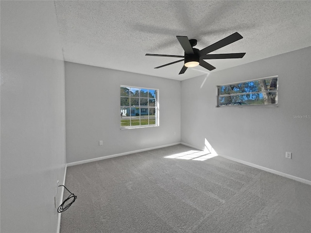 carpeted empty room with a textured ceiling and ceiling fan