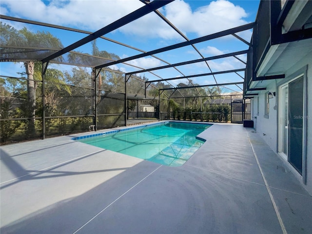 view of swimming pool featuring a patio and a lanai