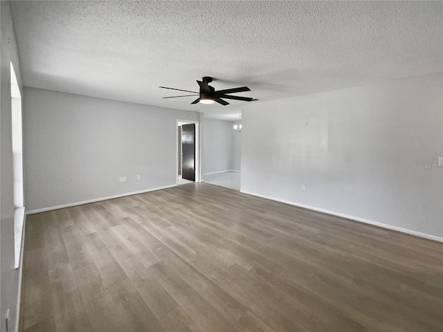 empty room with hardwood / wood-style floors, a textured ceiling, and ceiling fan