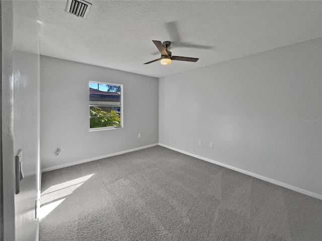 unfurnished room with a textured ceiling, ceiling fan, and carpet