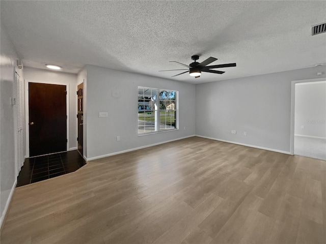 interior space with a textured ceiling, wood-type flooring, and ceiling fan