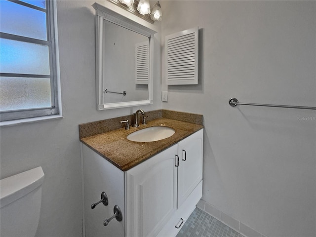 bathroom featuring vanity and toilet