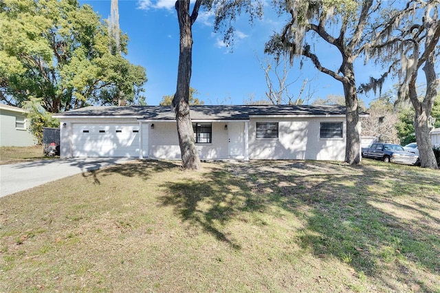 ranch-style home with a garage and a front yard