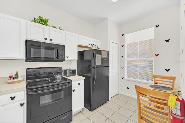 kitchen with white cabinetry, light tile patterned flooring, and black appliances