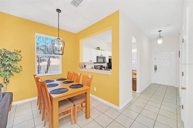 dining area with an inviting chandelier and light tile patterned floors