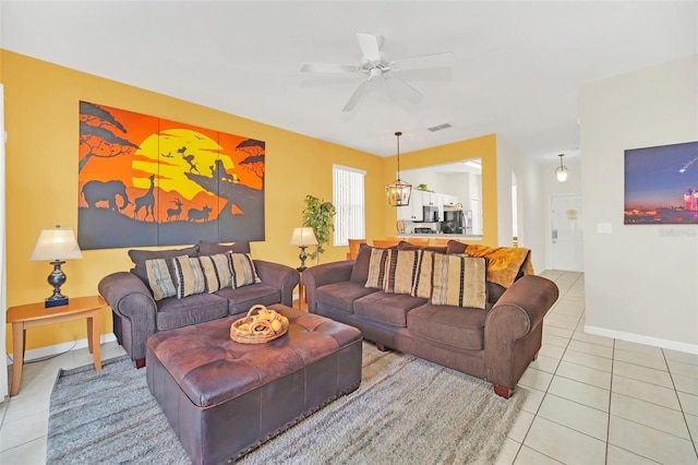 tiled living room featuring ceiling fan
