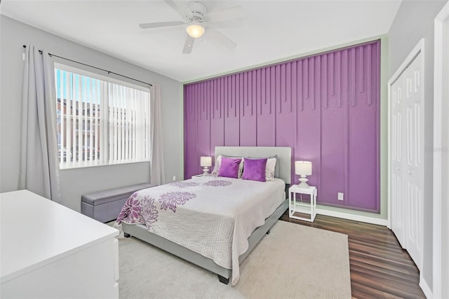 bedroom with hardwood / wood-style floors, ceiling fan, and a closet