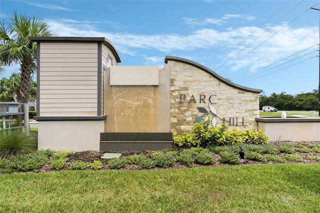 community sign featuring a yard