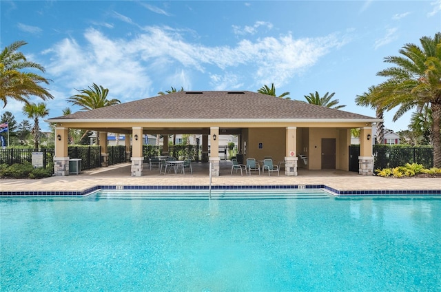 view of swimming pool with a patio and central air condition unit