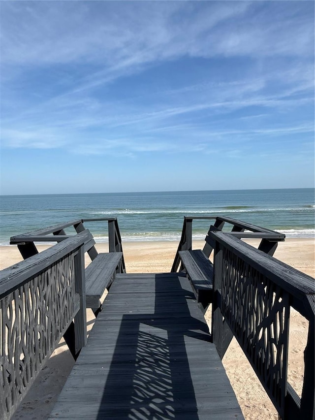 view of community with a water view and a view of the beach