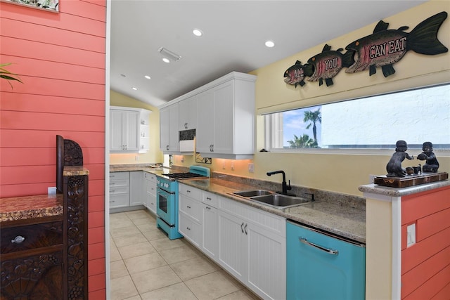 kitchen featuring stove, sink, white cabinetry, and light tile patterned flooring