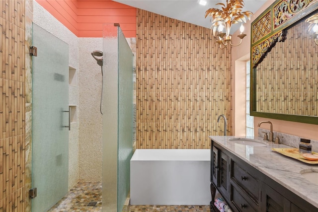 bathroom with vanity, wooden walls, independent shower and bath, and vaulted ceiling