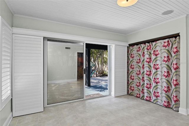 tiled spare room featuring ornamental molding