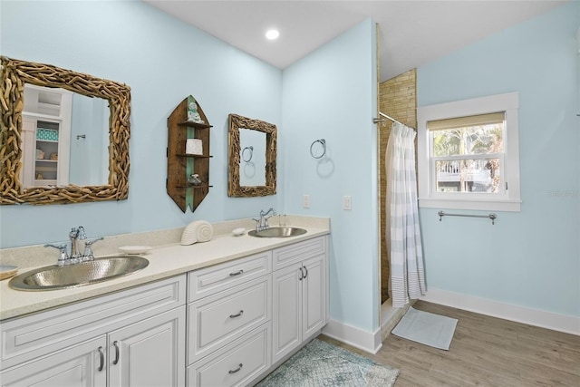 bathroom featuring a shower with curtain, wood-type flooring, and vanity