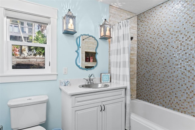 full bathroom featuring toilet, vanity, and shower / bath combo with shower curtain