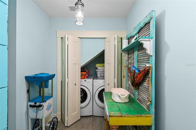 laundry area featuring hardwood / wood-style flooring and separate washer and dryer