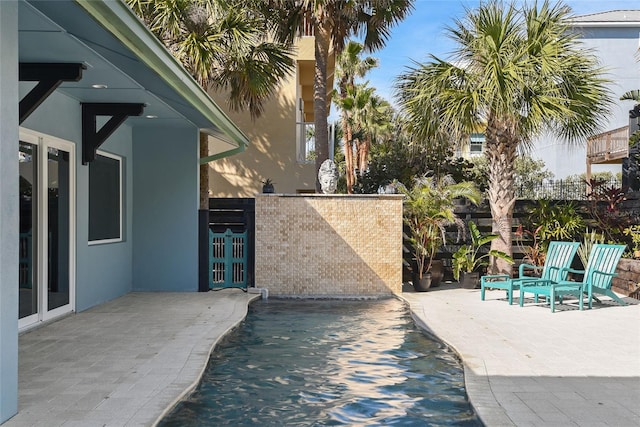 view of swimming pool with a patio area