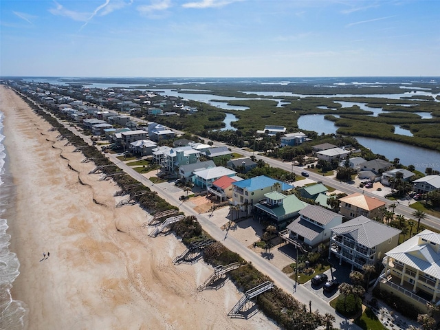 bird's eye view featuring a view of the beach and a water view