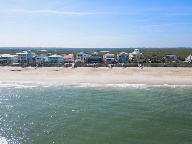 bird's eye view with a water view and a beach view