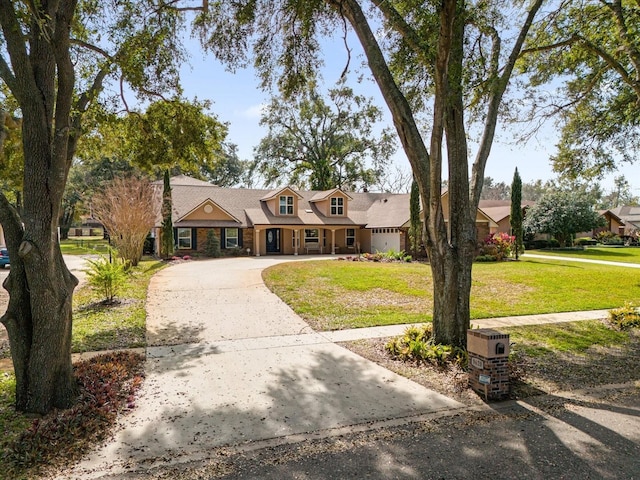 cape cod house featuring a garage and a front yard