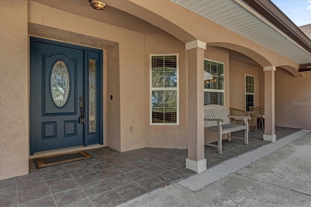 view of exterior entry with covered porch