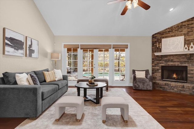 living room with lofted ceiling, a brick fireplace, dark hardwood / wood-style flooring, and french doors