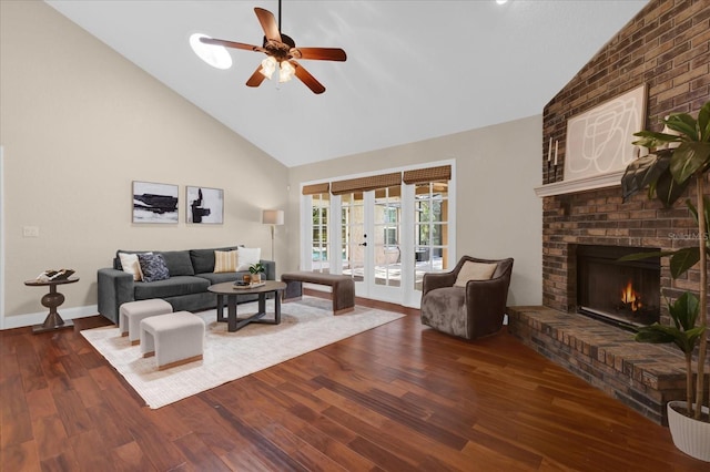 living room with high vaulted ceiling, a fireplace, dark hardwood / wood-style flooring, ceiling fan, and french doors