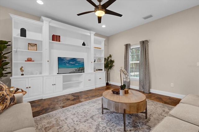 living room featuring built in features and ceiling fan