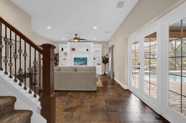 living room featuring french doors and ceiling fan