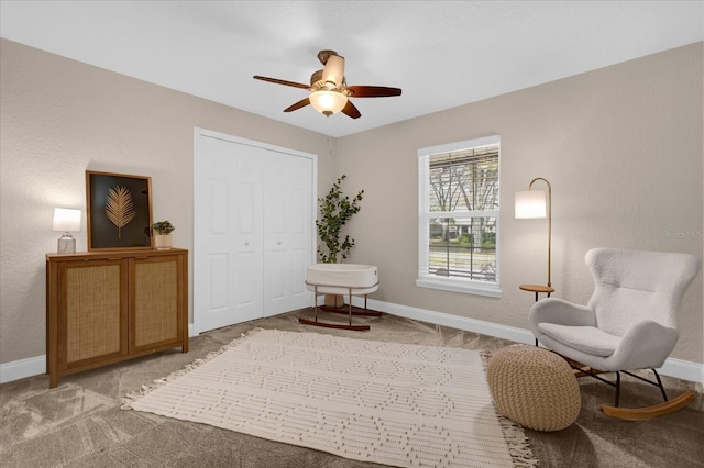 sitting room with light colored carpet and ceiling fan