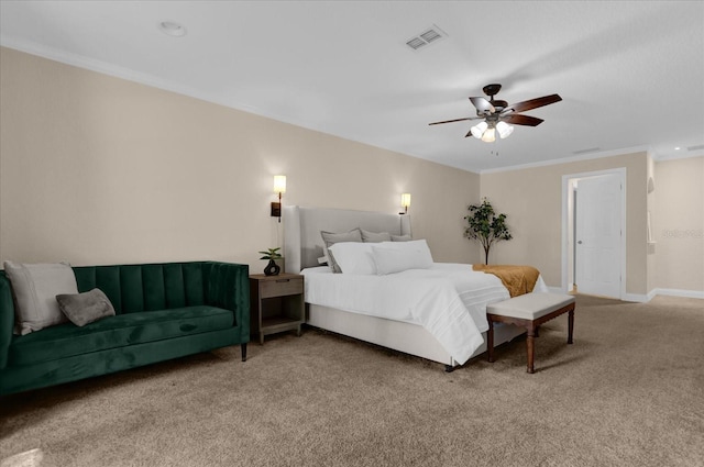 carpeted bedroom with ornamental molding and ceiling fan