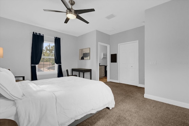 bedroom with ensuite bath, ceiling fan, and carpet flooring